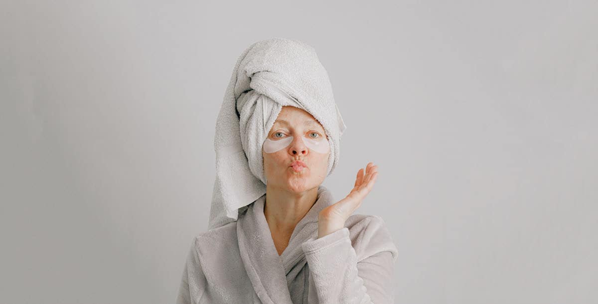 woman in dressing gown, towel turban and eye mask