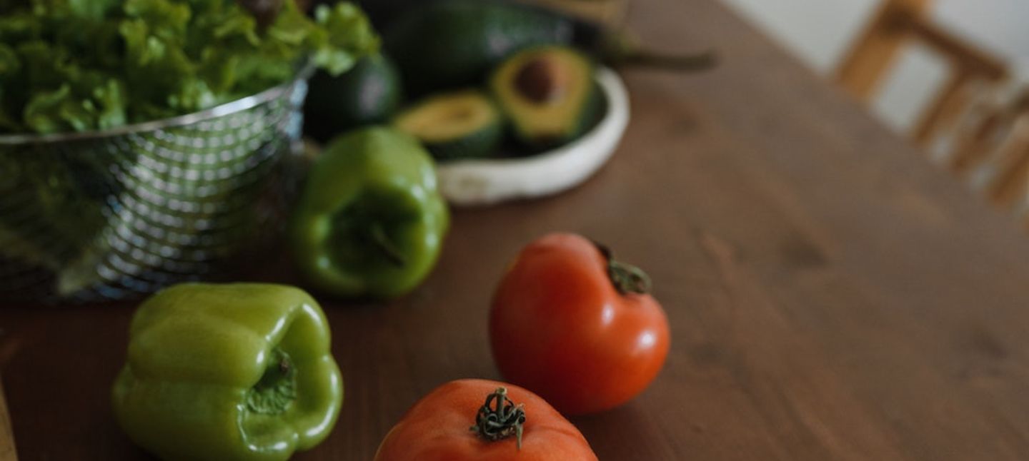 tomatoes and peppers on table