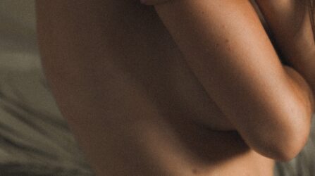 women touching her shoulder