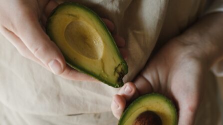 women with sliced avocado